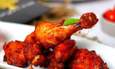 Tandoori chicken drumsticks on a white plate