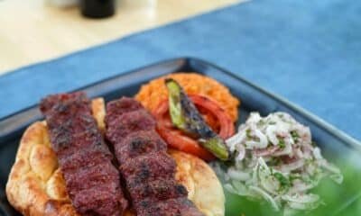 Two minced-meat kebabs on flatbread with salad